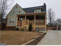 Two-story house with driveway, front porch and landscaped yard at 1420 Donnelly Ave, Atlanta, GA 30310