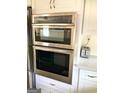 Stainless steel double oven and microwave combo, built into white cabinets at 1420 Donnelly Ave, Atlanta, GA 30310
