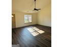 Bright living room with stylish wood floors and a window that provides natural light at 415 Dove Ln, Social Circle, GA 30025