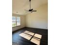 Spacious living room featuring vaulted ceilings, wood floors and a large window at 415 Dove Ln, Social Circle, GA 30025
