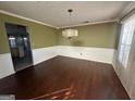 Bright dining room featuring hardwood floors and chandelier at 4010 Peachtree Farms Rd, Rex, GA 30273