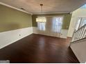 Formal dining room with hardwood floors and chandelier at 4010 Peachtree Farms Rd, Rex, GA 30273