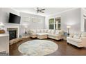 Relaxing living room featuring a stone fireplace and L-shaped sofa at 113 Overlook Ridge Way, Canton, GA 30114