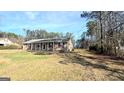 Ranch style home with a covered porch and spacious yard at 65 Merideth Trce, Sharpsburg, GA 30277