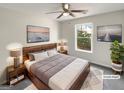 This staged bedroom features a ceiling fan, large window, and contemporary decor at 1535 Valley Club Dr, Lawrenceville, GA 30044