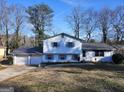 House exterior showcasing a two-car garage and a well-maintained lawn at 6628 Londonderry Dr, Morrow, GA 30260