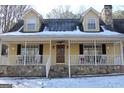 House exterior showcasing a charming front porch at 155 Carriage Gate Dr, Sharpsburg, GA 30277
