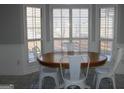 Bright eat-in kitchen with bay window and white cabinets at 155 Carriage Gate Dr, Sharpsburg, GA 30277
