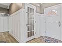 White-paneled entry hall with two doors and floral rug at 25 Highlands Way, Oxford, GA 30054