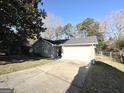 House exterior showcasing a gray brick finish and a single-car garage at 6595 Bellburn Rd, Atlanta, GA 30349
