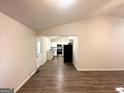 View into the kitchen with white cabinets and granite countertops at 6595 Bellburn Rd, Atlanta, GA 30349
