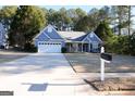 Blue house with driveway and mailbox at 756 Stonehaven Chase, Mcdonough, GA 30253