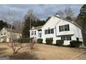 Two-story house with a white exterior, landscaping, and a driveway at 135 Tuscany Trce, Dallas, GA 30157