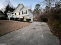 House exterior view at dusk with a long driveway and fenced backyard at 135 Tuscany Trce, Dallas, GA 30157