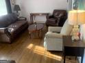 Living room with hardwood floors, leather furniture, and lamps at 2276 Hillside Ave, Decatur, GA 30032