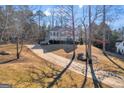 Two-story house with gray siding, long driveway, and trees at 85 Pecan Ln, Oxford, GA 30054