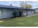 Home's back features a patio and a grassy area at 3477 Se Creekwood Se Dr, Conyers, GA 30094