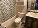 Bathroom with a shower/tub combo, vanity, and updated flooring at 3477 Se Creekwood Se Dr, Conyers, GA 30094