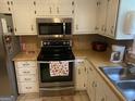 Galley kitchen with stainless steel appliances and wood cabinets at 3477 Se Creekwood Se Dr, Conyers, GA 30094