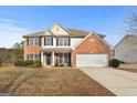 Two-story home with a brick facade and a covered porch at 985 Buckhorn Bnd, Locust Grove, GA 30248
