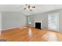 Bright living room featuring a fireplace, ceiling fan and a door to the backyard at 633 Westbridge Rd, Fayetteville, GA 30214