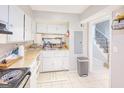 Small kitchen with white cabinets and a double sink at 6036 Regent Mnr, Lithonia, GA 30058