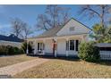White house with a porch, brick walkway, and American flag at 2173 Anderson Se Ave, Covington, GA 30014