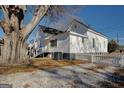 Side view of a white house with a large tree and a white picket fence at 2173 Anderson Se Ave, Covington, GA 30014