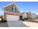 Two-story house with a two-car garage and large driveway at 308 San Anselmo St, Locust Grove, GA 30248