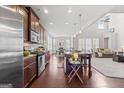 Open-concept kitchen features stainless steel appliances, granite countertops, and a large island with seating at 244 Sturry Dr, Mcdonough, GA 30252