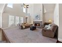 Spacious living room featuring a brick fireplace, large windows, vaulted ceilings, and comfortable seating at 244 Sturry Dr, Mcdonough, GA 30252
