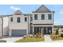 Beautiful home with a two-car garage, a paved driveway, a brick exterior, and manicured landscaping at 1946 Westwind Street # 132, Lawrenceville, GA 30043