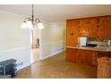 Bright dining area with wood cabinets and chandelier at 626 Barksdale Dr, Forest Park, GA 30297