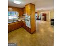 Galley kitchen with wood cabinets and appliances at 626 Barksdale Dr, Forest Park, GA 30297