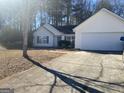 House exterior showcasing a driveway and attached garage at 216 Cane Se Ave, Social Circle, GA 30025