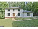 Inviting two-story home with a classic design and well-maintained lawn and landscaping at 215 Kingswood Dr, Fayetteville, GA 30215