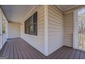 Side porch with wooden flooring and railings at 169 Holly Ct, Loganville, GA 30052