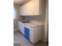White kitchen cabinets, granite countertops, and dishwasher at 2176 Lilac Ln, Decatur, GA 30032