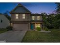 Two-story house with a neutral color scheme and a teal front door, at dusk at 149 Pristine Dr, Locust Grove, GA 30248