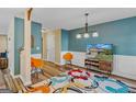 Bright living room with hardwood floors, colorful rug, and a TV at 149 Pristine Dr, Locust Grove, GA 30248