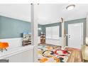 Living room with hardwood floors, colorful rug and a view of the front door at 149 Pristine Dr, Locust Grove, GA 30248