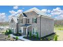Side view of a two-story brick home with landscaping at 113 Broder Farms Dr # 387, Stockbridge, GA 30281
