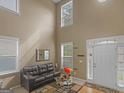 Spacious living room with high ceilings, hardwood floors, and large windows at 7356 Blue Jay Way, Union City, GA 30291