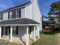 Gray siding two-story house with covered porch and backyard at 9418 Sleepy Hollow Ln, Jonesboro, GA 30238