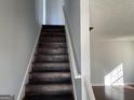 Dark wood staircase leading to the second floor at 9418 Sleepy Hollow Ln, Jonesboro, GA 30238