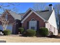 Attractive brick home with dark shutters, mature landscaping, and a well-kept lawn at 213 Meridian Dr, Stockbridge, GA 30281