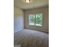Spacious bedroom with neutral carpeting and a large window at 5711 Laney Dr # Ln24, Rex, GA 30273