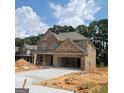 Brick two-story house with a two-car garage and new construction at 5711 Laney Dr # Ln24, Rex, GA 30273