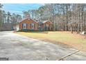 House exterior with driveway and landscaping at 140 Alford Dr, Fayetteville, GA 30215
