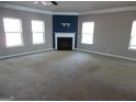 Large living room with fireplace, neutral walls, and carpeting at 1340 Napa Valley Dr, Lawrenceville, GA 30045